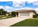 Attractive single-story home with a paved driveway and well-manicured lawn at 1623 Faxton Dr, Sun City Center, FL 33573