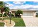 Landscaped front yard with palm trees and a brick driveway at 1623 Faxton Dr, Sun City Center, FL 33573