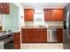 Well-equipped kitchen featuring wood cabinets, granite counters, and stainless steel appliances at 1623 Faxton Dr, Sun City Center, FL 33573