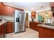 Modern kitchen with wood cabinets, granite countertops, and stainless steel appliances at 1623 Faxton Dr, Sun City Center, FL 33573