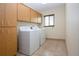 Bright laundry room with washer, dryer, and ample cabinets at 1623 Faxton Dr, Sun City Center, FL 33573