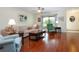 Bright living room featuring hardwood floors, comfy furniture, and a ceiling fan at 1623 Faxton Dr, Sun City Center, FL 33573