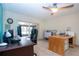 Home office with built-in desk and access to a lanai at 1623 Faxton Dr, Sun City Center, FL 33573
