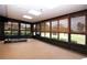 Bright sunroom featuring large windows and a treadmill at 1623 Faxton Dr, Sun City Center, FL 33573