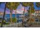 Stunning sunset view over the marina, boats, and palm trees at 363 Pinellas Bayway S # 33, Tierra Verde, FL 33715