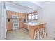 Galley kitchen with white appliances and breakfast bar at 502 Hilldale Rd, Brandon, FL 33510