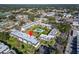 Aerial shot of the condo complex surrounded by lush greenery, parking and featuring a community pool at 716 Oakgrove Dr # 240, Brandon, FL 33510