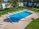 Aerial view of a community pool with lounge chairs and lush landscaping in a serene setting at 716 Oakgrove Dr # 240, Brandon, FL 33510