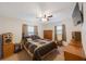 Bedroom with a queen-size bed, ceiling fan, and wood dresser at 8254 40Th N Ave, St Petersburg, FL 33709