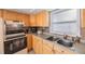 Kitchen boasts wood cabinets, tile backsplash and double sink at 8254 40Th N Ave, St Petersburg, FL 33709