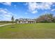 Gorgeous single-story home with lush green lawn and mature landscaping, featuring a modern farmhouse design at 937 Old Welcome Rd, Lithia, FL 33547