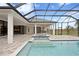 Sparkling pool and raised spa feature dark blue tile and travertine pool deck at 937 Old Welcome Rd, Lithia, FL 33547