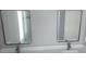 Bathroom features dual vanity with contemporary fixtures and framed mirrors over the sinks at 103 2Nd Ne Ave, Lutz, FL 33549