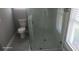 Modern bathroom featuring a sleek glass-enclosed shower with white marble tile surround at 103 2Nd Ne Ave, Lutz, FL 33549