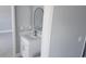 Modern bathroom vanity with white cabinets, white quartz countertop, and contemporary mirror at 103 2Nd Ne Ave, Lutz, FL 33549