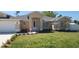 Inviting single-story home with fresh landscaping and a well-manicured front lawn at 103 2Nd Ne Ave, Lutz, FL 33549
