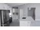 Bright kitchen with white cabinets, stainless steel appliances, and a large island with quartz countertops at 103 2Nd Ne Ave, Lutz, FL 33549
