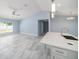Light filled living space featuring tile floors, vaulted ceiling and modern fixtures at 103 2Nd Ne Ave, Lutz, FL 33549