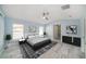 Bright main bedroom with ensuite bathroom, a ceiling fan, and neutral decor at 103 2Nd Ne Ave, Lutz, FL 33549