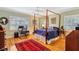 Spacious bedroom with hardwood floors, a four poster bed, and a built-in workspace at 105 Estado Ne Way, St Petersburg, FL 33704