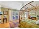 Bright bedroom with wood floors, a four-poster bed, and access to a private patio at 105 Estado Ne Way, St Petersburg, FL 33704