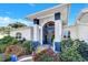 Elegant entryway with double doors, lush landscaping, and brick walkway at 105 Estado Ne Way, St Petersburg, FL 33704