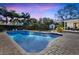 Inviting kidney-shaped pool with brick patio and lush landscaping at 105 Estado Ne Way, St Petersburg, FL 33704