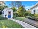 Landscaped backyard with charming shed and brick pathway at 105 Estado Ne Way, St Petersburg, FL 33704