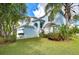 Two-story light blue house with lush landscaping and palm trees at 10816 Lakeside Vista Dr, Riverview, FL 33569