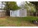 Two storage sheds in the backyard, one with X-design doors at 1505 New Bedford Dr, Sun City Center, FL 33573