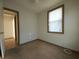 Small bedroom with one window, carpet, and access to hallway at 1708 Preston S St, St Petersburg, FL 33712