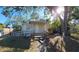 Front view of a light tan house with a white ramp and mature trees at 1708 Preston S St, St Petersburg, FL 33712