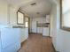 Bright kitchen features white cabinets, tile floors, and appliances at 1708 Preston S St, St Petersburg, FL 33712