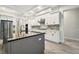 Large kitchen island with dark gray cabinets and a granite countertop at 19504 Sheltered Hill Dr, Brooksville, FL 34601