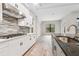 Modern kitchen with white cabinets, granite countertops, and stainless steel appliances at 19504 Sheltered Hill Dr, Brooksville, FL 34601