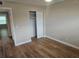 Simple bedroom with hardwood floors and a closet at 2359 Finlandia Ln # 27, Clearwater, FL 33763