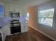 Modern kitchen with white cabinets, stainless steel appliances, and quartz countertops at 2359 Finlandia Ln # 27, Clearwater, FL 33763