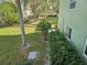 Green backyard with mature trees and shrubs at 2359 Finlandia Ln # 27, Clearwater, FL 33763