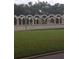 Landscaped area with an arched wall and lush lawn at 2359 Finlandia Ln # 27, Clearwater, FL 33763