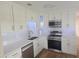 Modern kitchen with white cabinets, stainless steel appliances, and quartz countertops at 2359 Finlandia Ln # 27, Clearwater, FL 33763