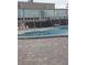 Community pool with surrounding patio and building in the background at 2359 Finlandia Ln # 27, Clearwater, FL 33763