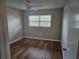Bright bedroom featuring wood-look flooring and neutral walls at 2359 Finlandia Ln # 27, Clearwater, FL 33763