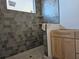 New bathroom with gray tile shower and light wood vanity at 2503 E 19Th Ave, Tampa, FL 33605