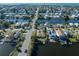 Wide aerial view of waterfront property with a canal and many houses visible at 3306 Holly Springs Dr, Hernando Beach, FL 34607