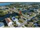 Aerial view showing a house next to a canal, with a camper and neighboring houses visible at 3306 Holly Springs Dr, Hernando Beach, FL 34607