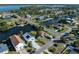 Aerial view showing a house next to a canal, with a camper and neighboring houses visible at 3306 Holly Springs Dr, Hernando Beach, FL 34607