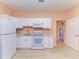 Small kitchen with white cabinets and stainless steel appliances at 397 Doniphan Dr, Port Charlotte, FL 33954