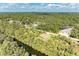 Aerial view of a house near a waterway, surrounded by lush greenery at 397 Doniphan Dr, Port Charlotte, FL 33954