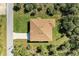 Aerial view of a single-story house with a brown roof and surrounding yard at 397 Doniphan Dr, Port Charlotte, FL 33954