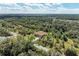Aerial view showing a house nestled in a lush green landscape at 397 Doniphan Dr, Port Charlotte, FL 33954